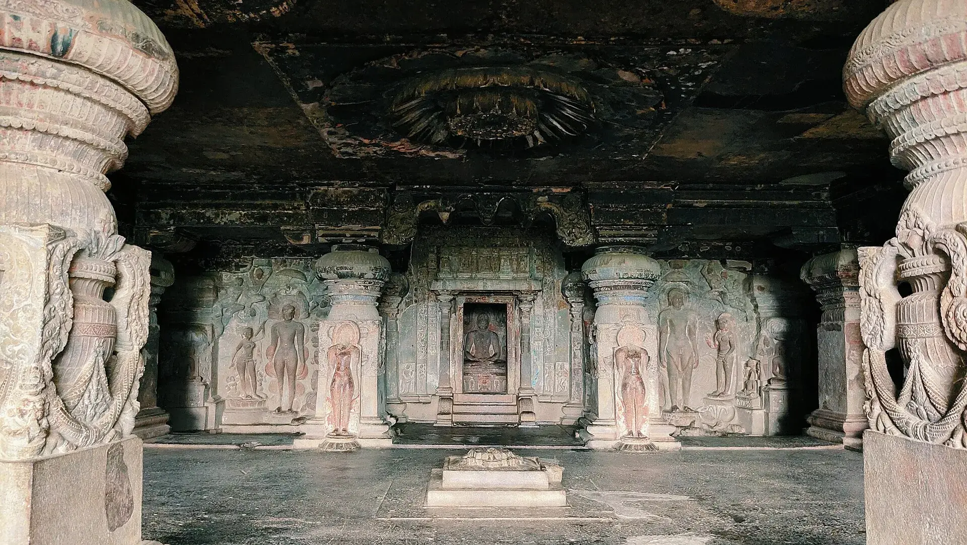 The Indra Sabha at Ellora, the Jain cave temple numbered thirty-two, with its carved courtyard shrine standing free of the rock face behind it.